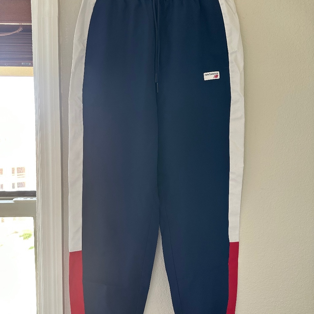 NEW BALANCE NB ATHLETICS WINDBREAKER PANTS